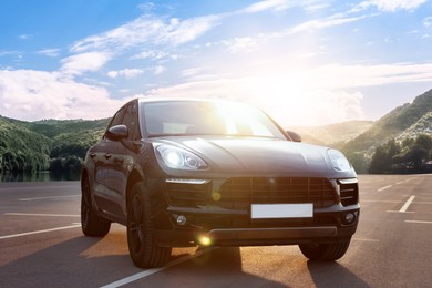 Modern car on asphalt road in mountains