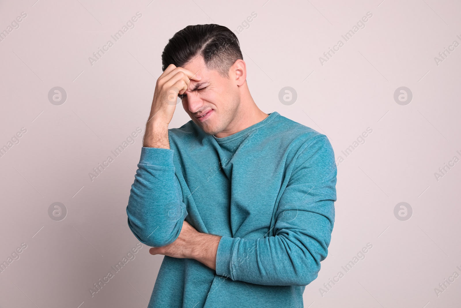 Photo of Portrait of stressed man on light background