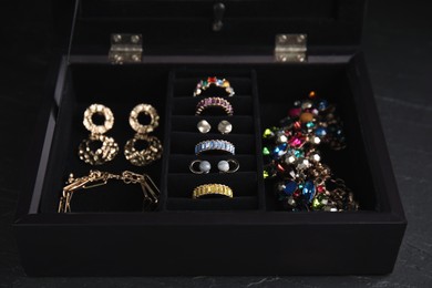 Photo of Jewelry box with stylish bijouterie on black table