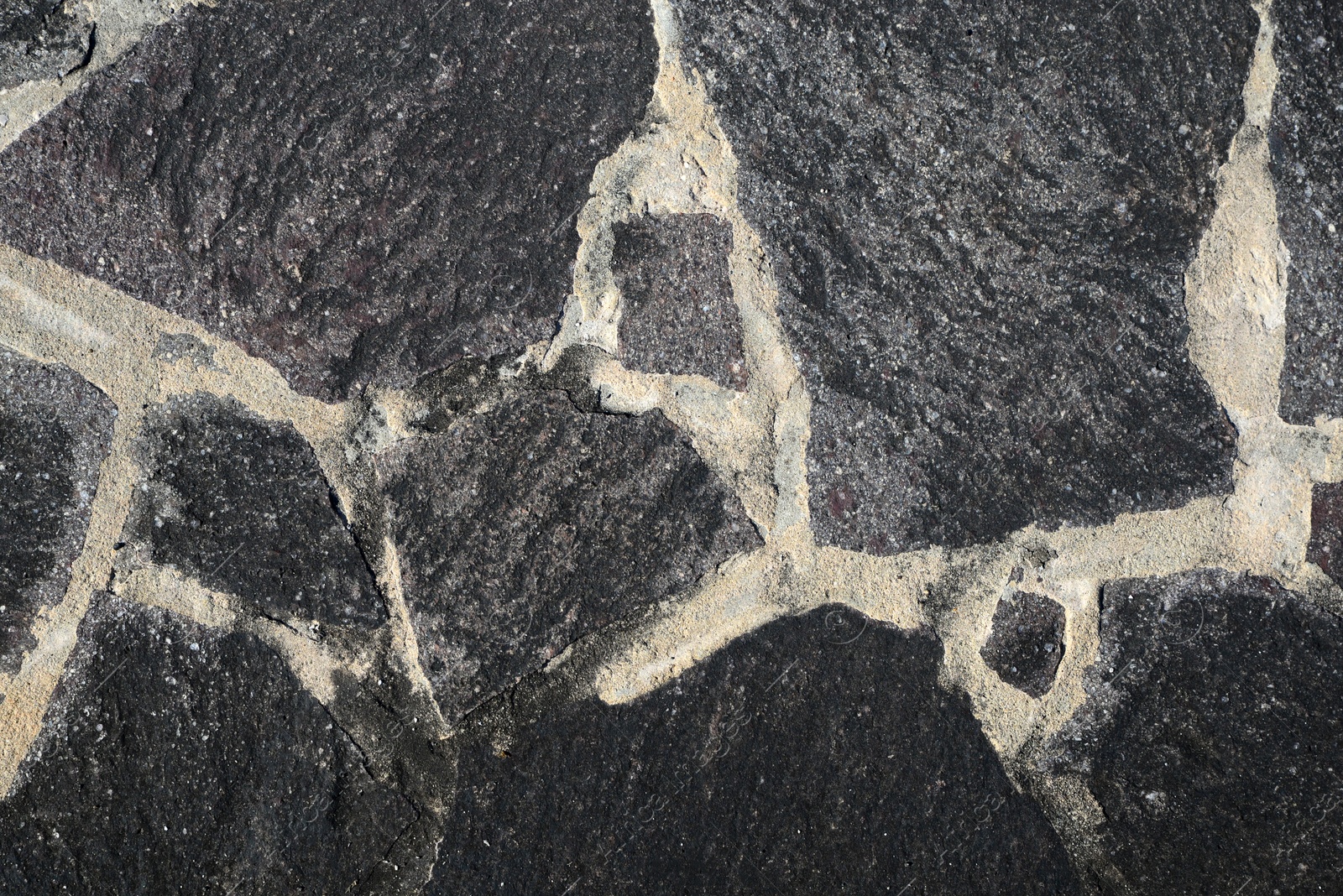 Photo of Texture of black stone surface as background, top view