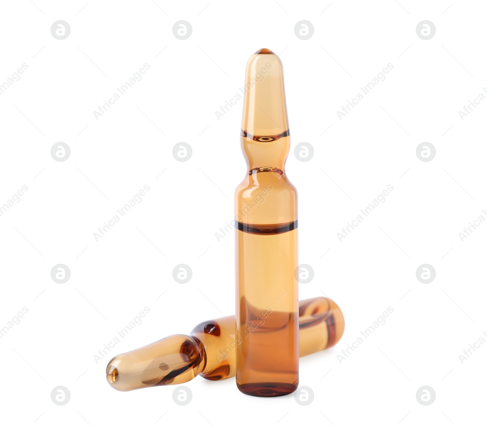 Photo of Brown pharmaceutical ampoules with medication on white background