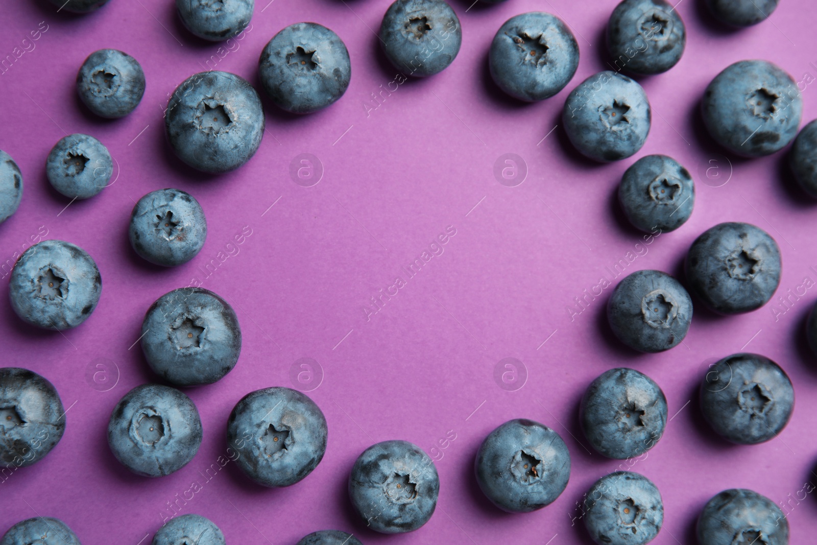 Photo of Flat lay composition with tasty blueberry and space for text on color background