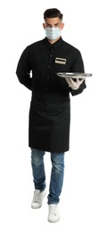 Waiter in medical face mask holding tray on white background