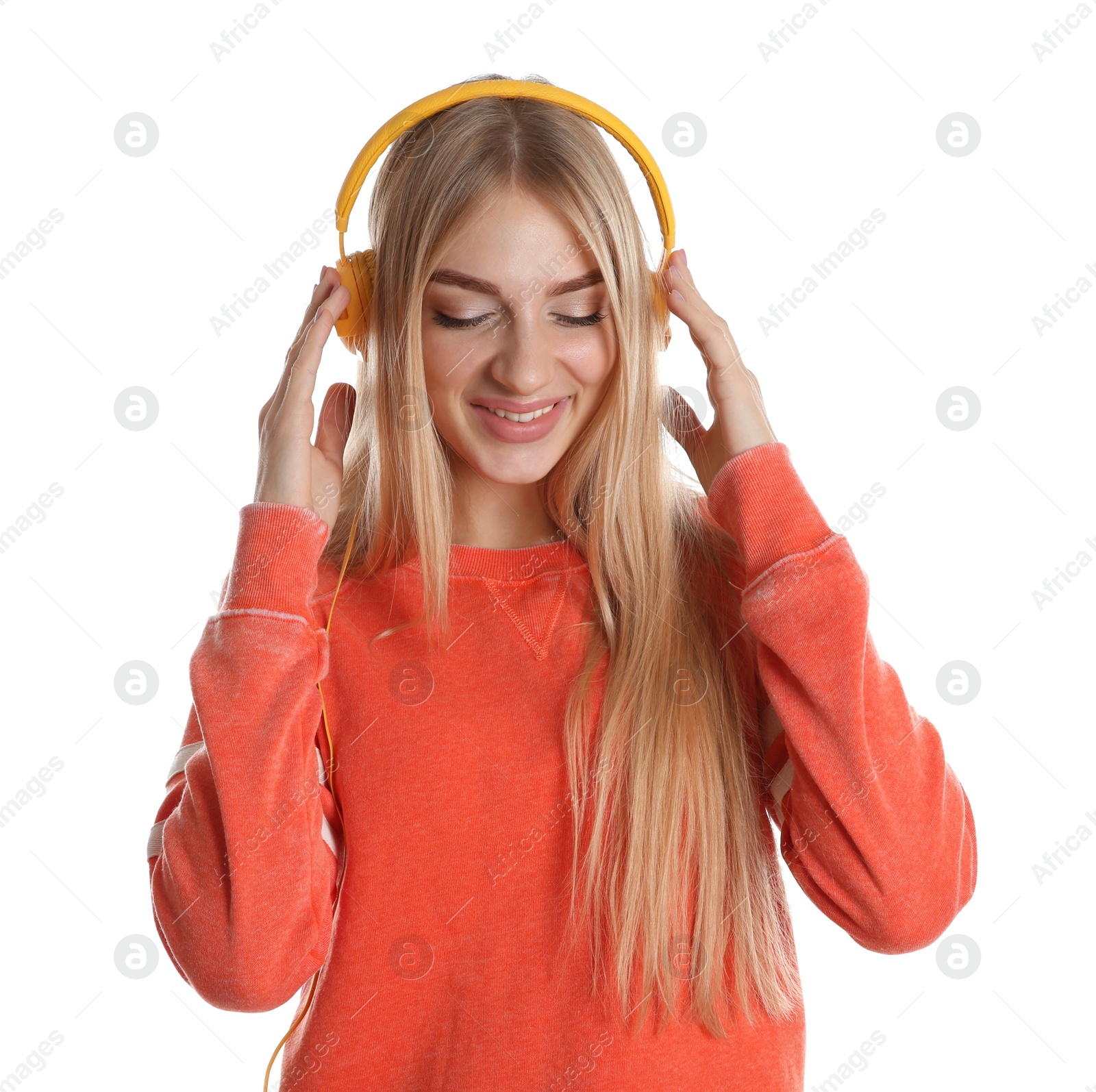 Photo of Beautiful young woman listening to music with headphones on white background