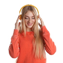 Beautiful young woman listening to music with headphones on white background