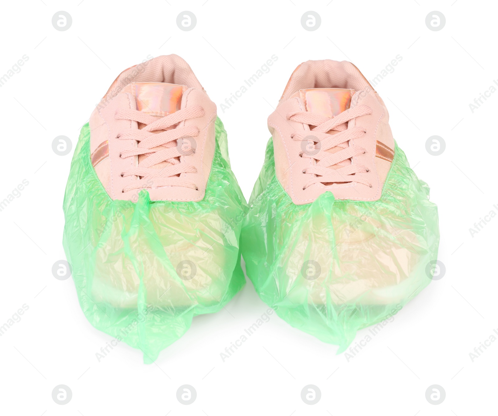 Photo of Sneakers in green shoe covers isolated on white