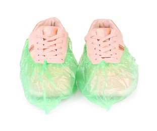 Photo of Sneakers in green shoe covers isolated on white