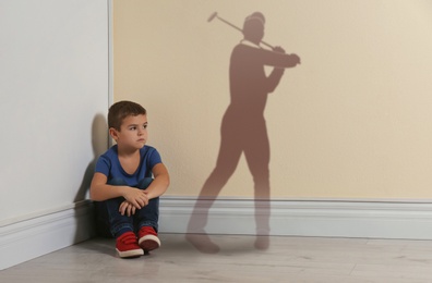 Little boy dreaming to be golf player. Silhouette of man behind kid's back