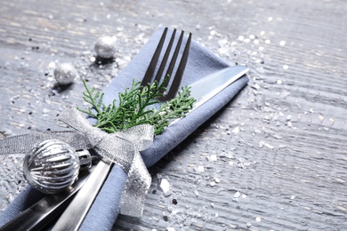 Photo of Cutlery set on grey wooden table, closeup. Christmas celebration