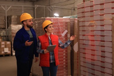 Image of Manager and worker at warehouse. Logistics center