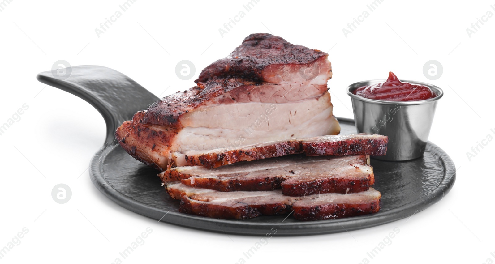 Photo of Pieces of tasty baked pork belly and sauce isolated on white