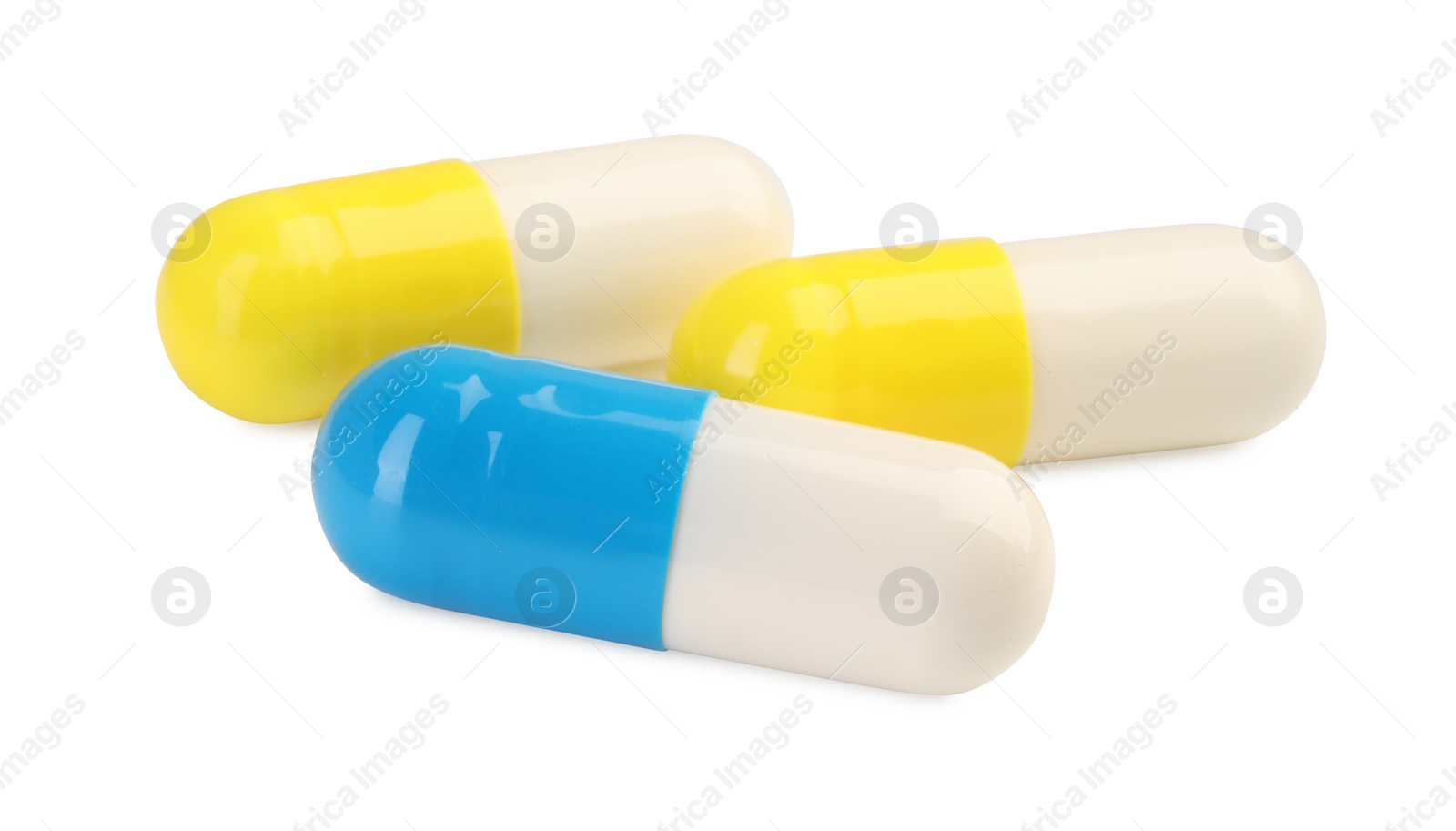 Photo of Three antibiotic pills isolated on white. Medicinal treatment