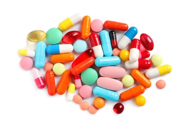 Photo of Pile of different colorful pills on white background, above view