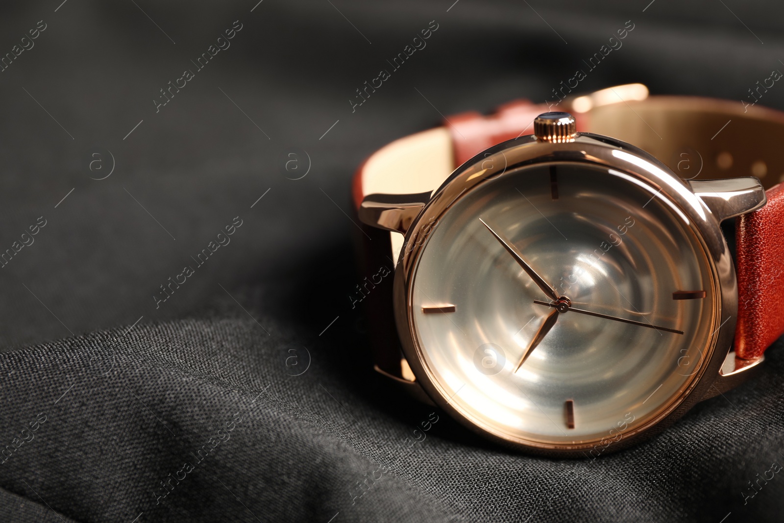 Photo of Luxury wrist watch on black background, closeup. Space for text