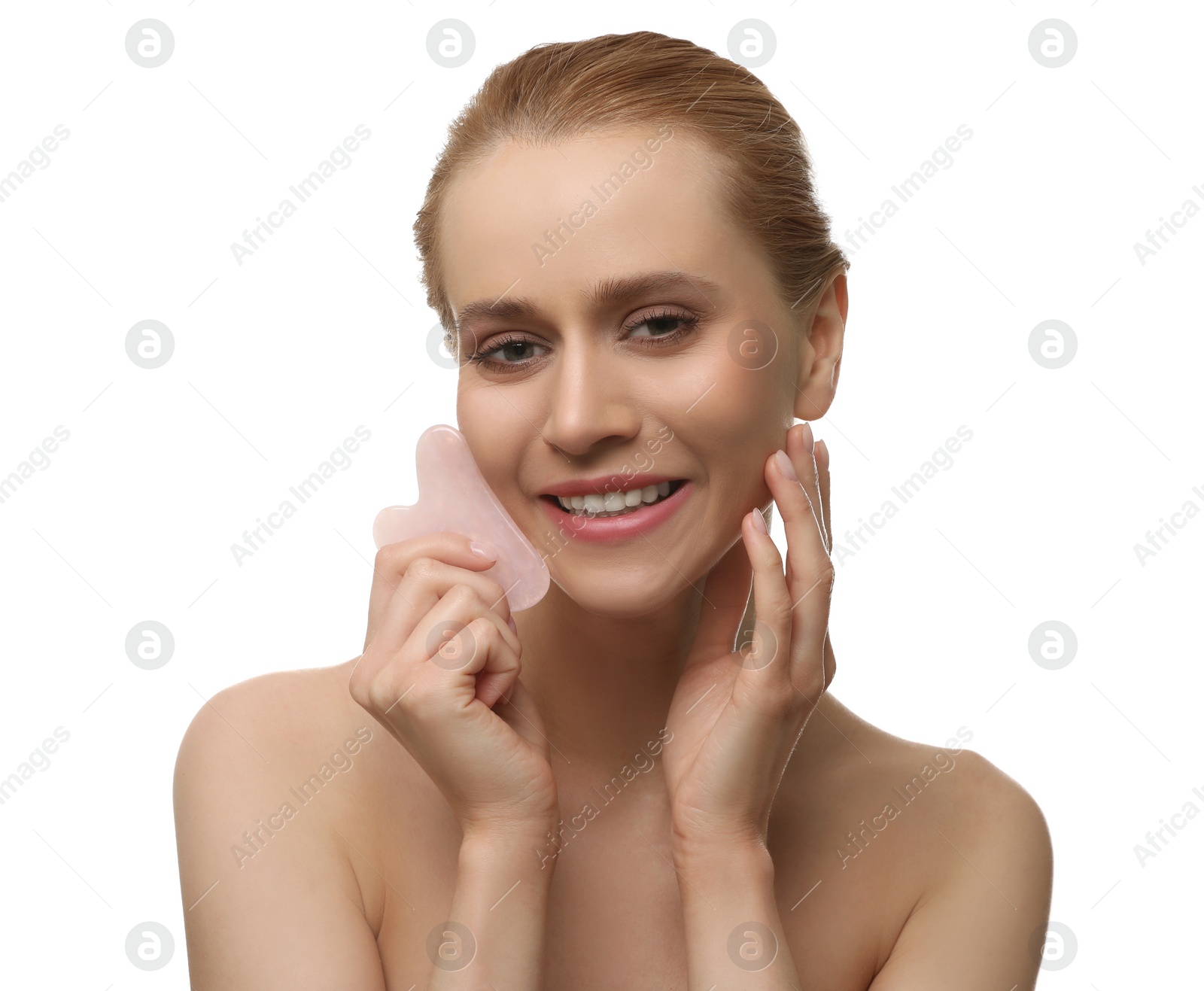 Photo of Beautiful young woman doing facial massage with gua sha tool on white background