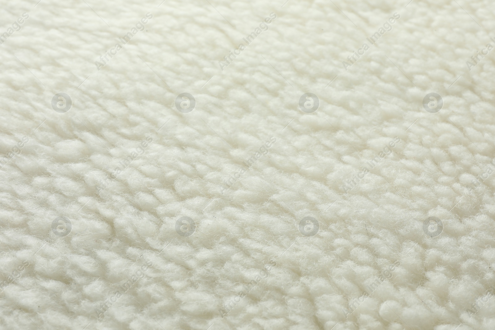 Photo of Texture of white fleece fabric as background, top view