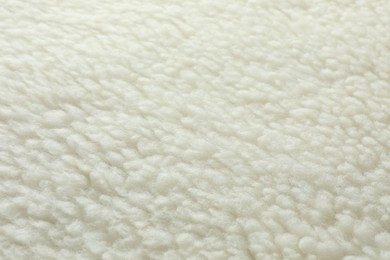 Photo of Texture of white fleece fabric as background, top view