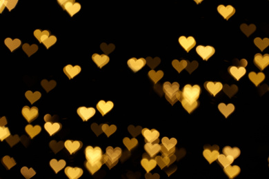 Photo of Blurred view of heart shaped lights on black background. Bokeh effect