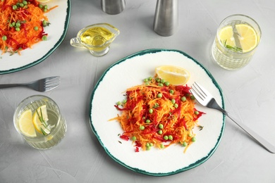 Plate with tasty carrot salad on table, top view