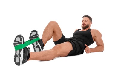 Young man exercising with elastic resistance band on white background