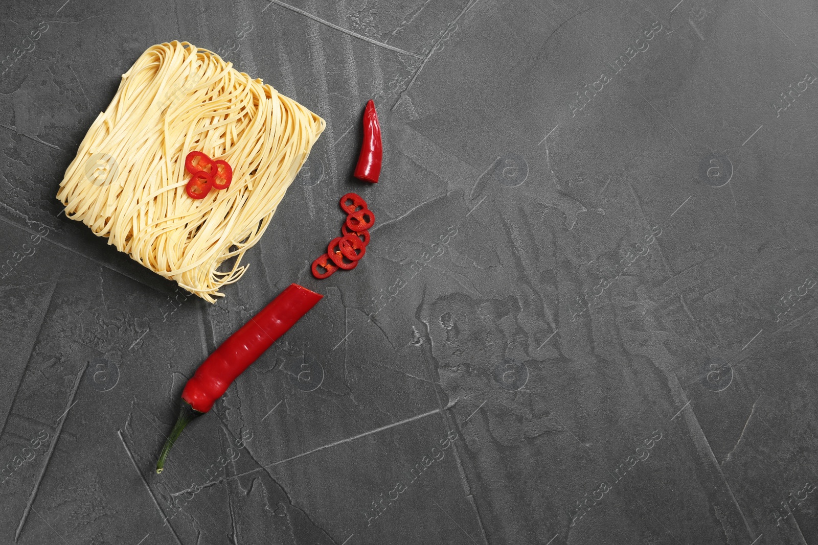 Photo of Flat lay composition with quick cooking noodles and space for text on color background