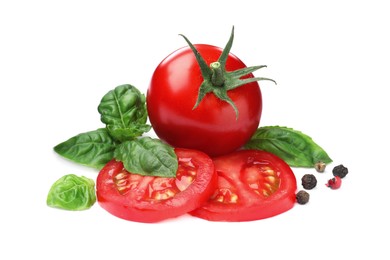 Fresh green basil leaves, spices with cut and whole tomatoes on white background, top view