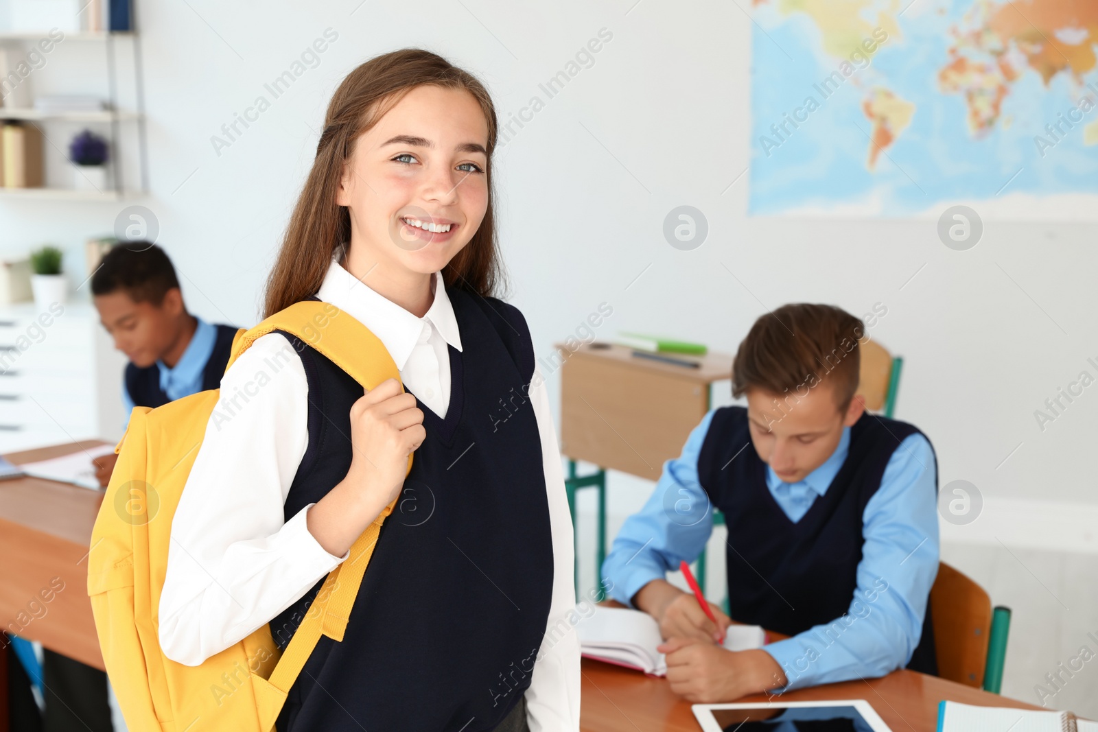 Photo of Teenage student in classroom. Stylish school uniform