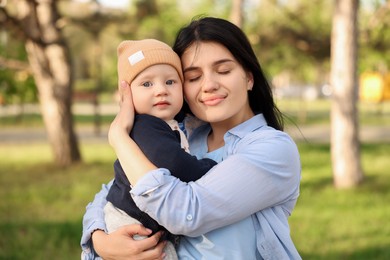 Photo of Family portrait of mother and her baby outdoors