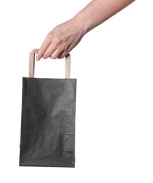 Woman holding paper shopping bag on white background, closeup