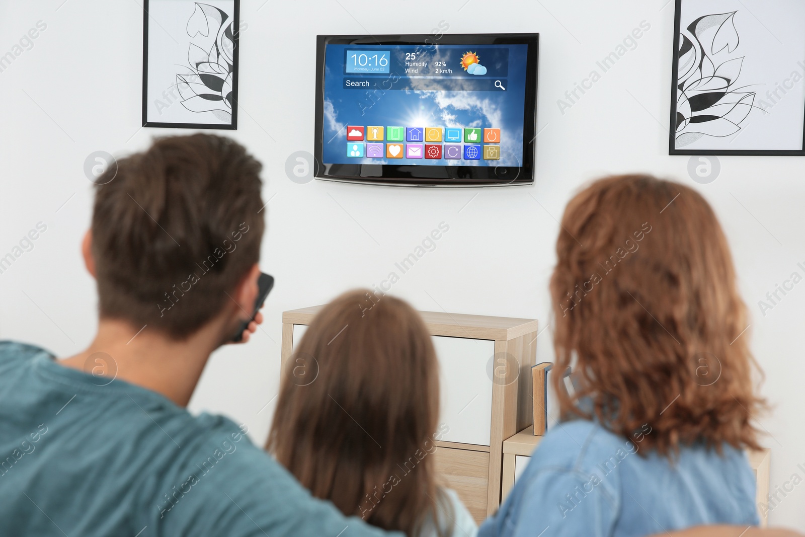 Image of Family watching smart TV in living room