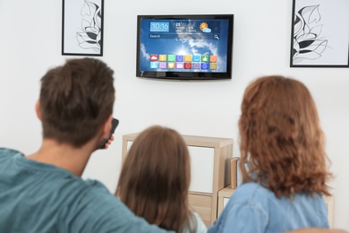 Image of Family watching smart TV in living room