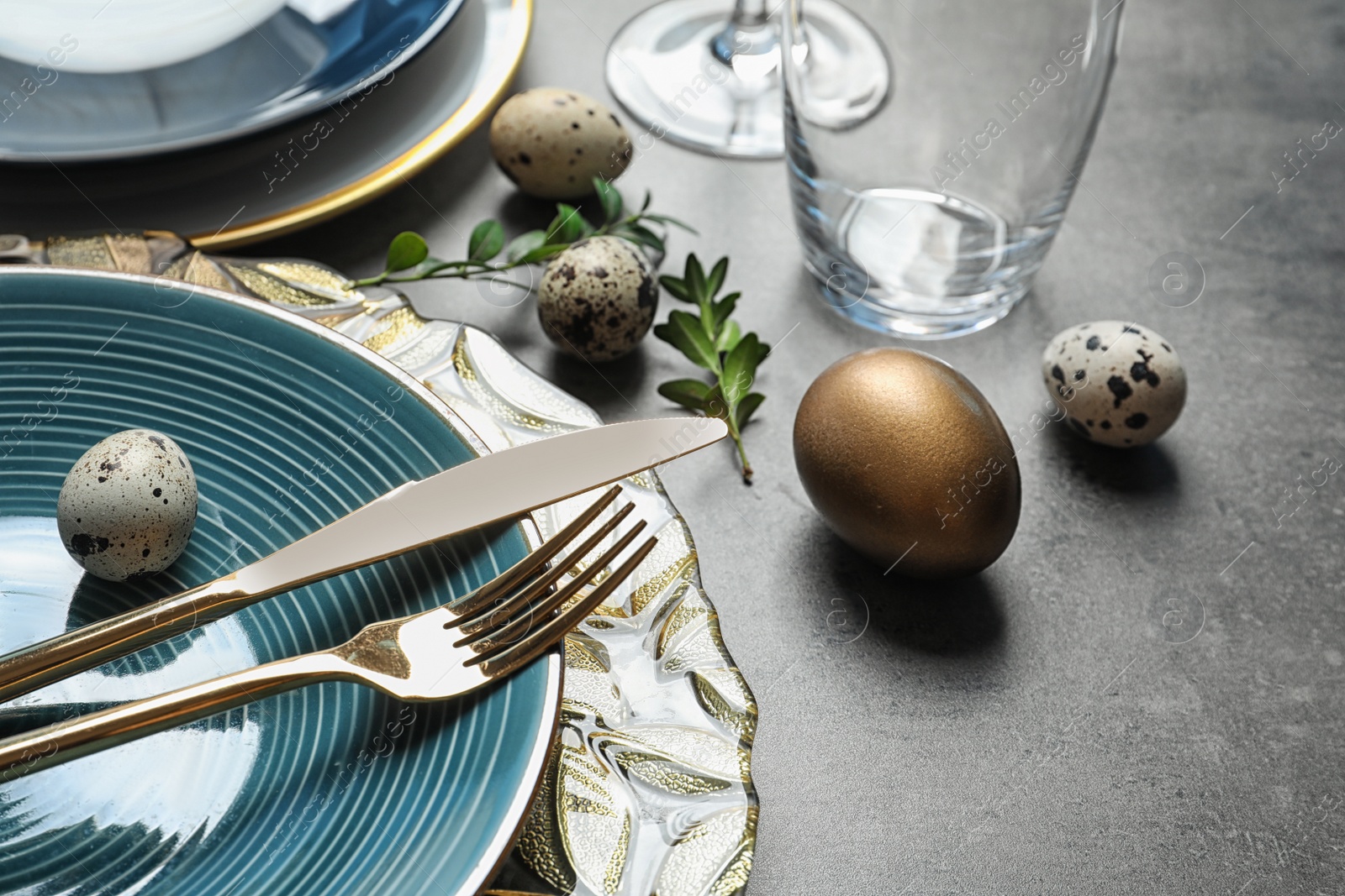 Photo of Festive Easter table setting with eggs on color background