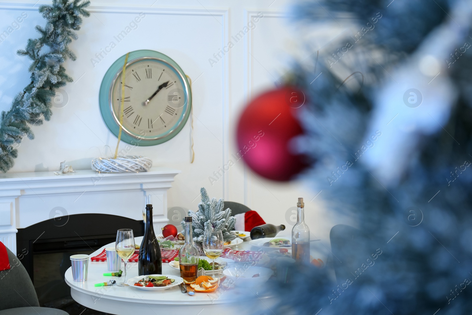 Photo of Dirty dishes on table in room. Mess after new year party