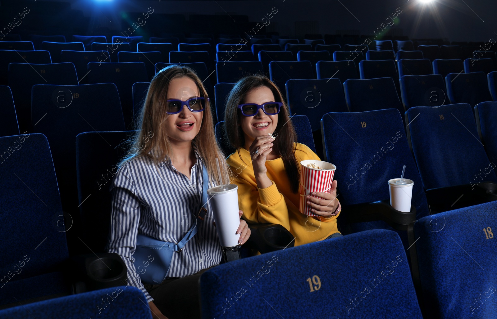 Photo of Young women watching movie in cinema theatre