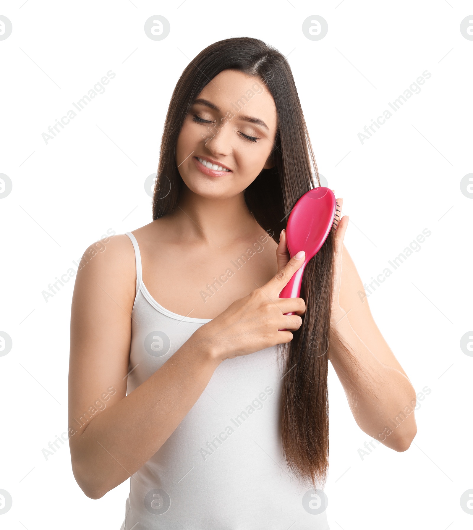 Photo of Beautiful young woman with hair brush on white background