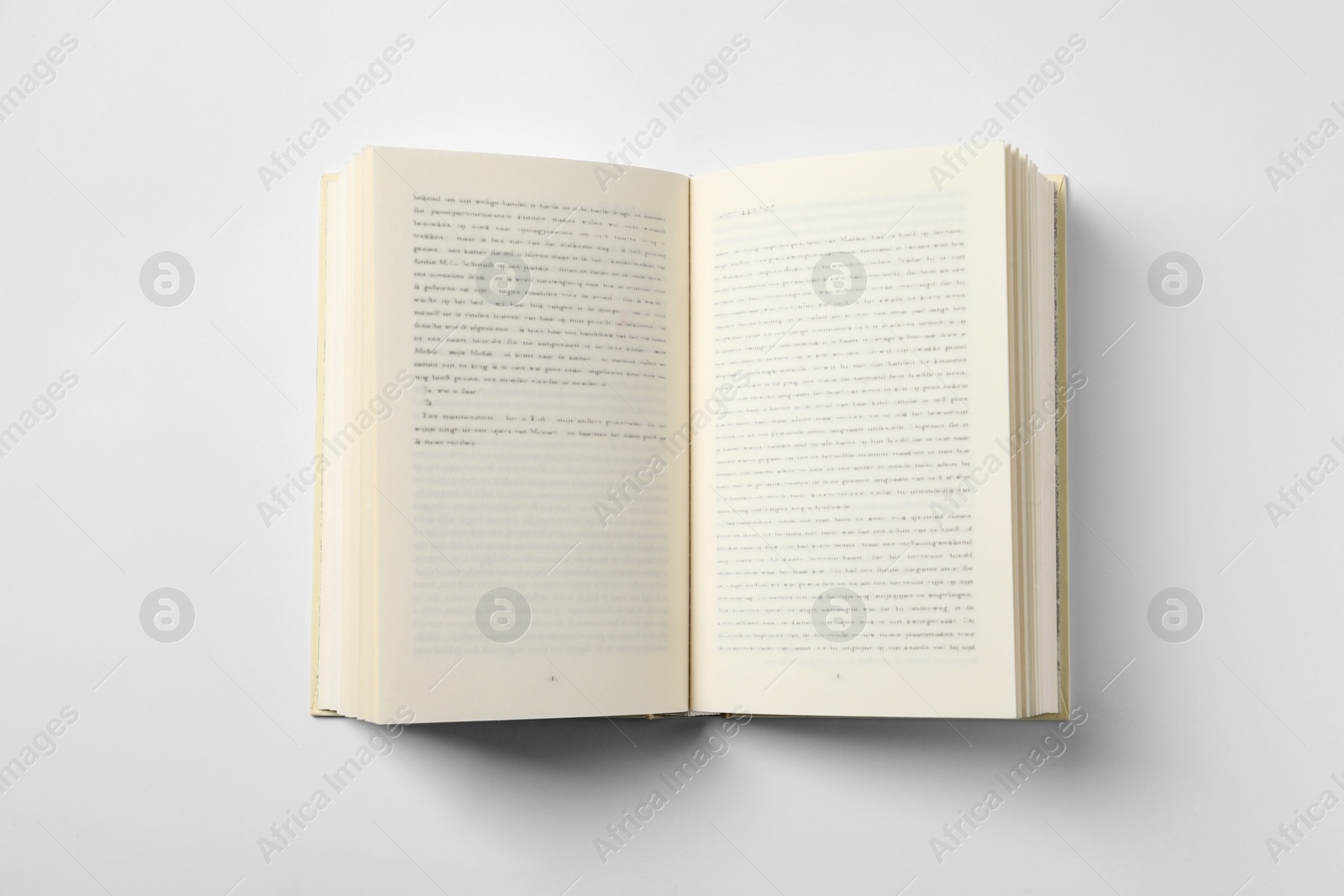 Photo of Open book on white background, top view