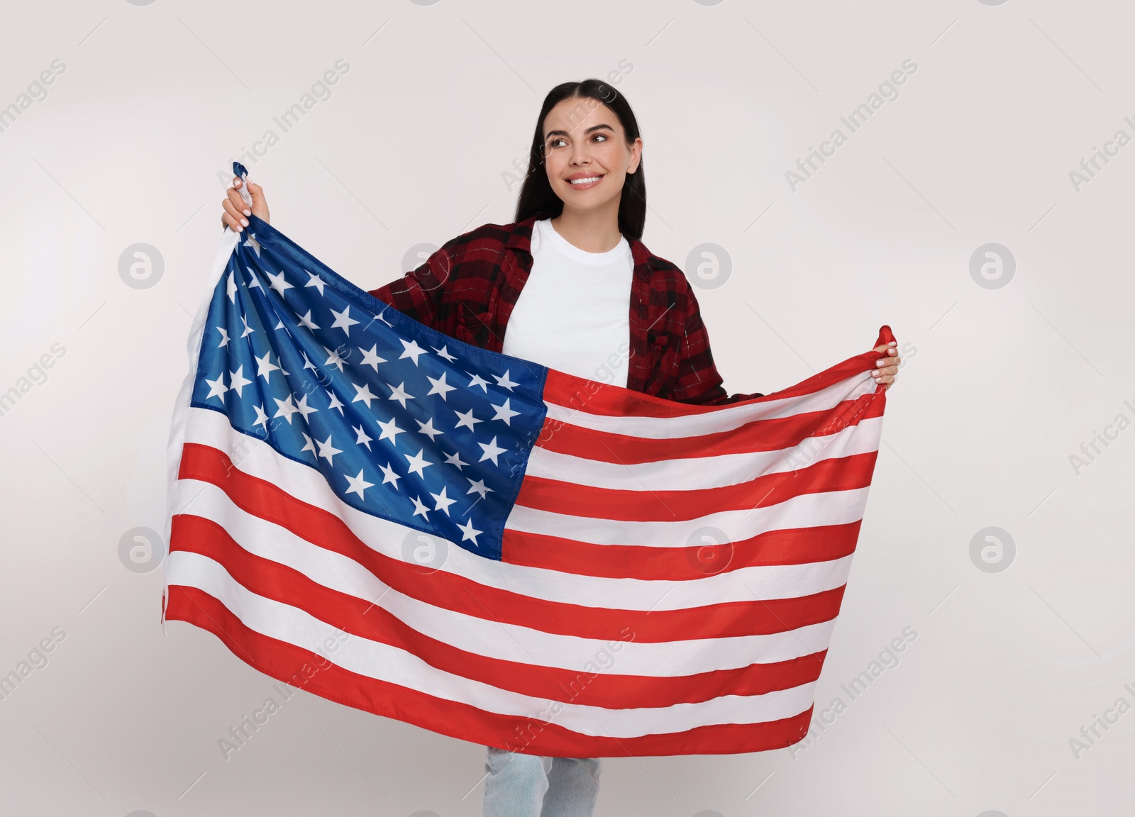 Photo of 4th of July - Independence Day of USA. Happy woman with American flag on white background