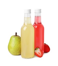 Delicious kombucha in glass bottles, pear and strawberries isolated on white