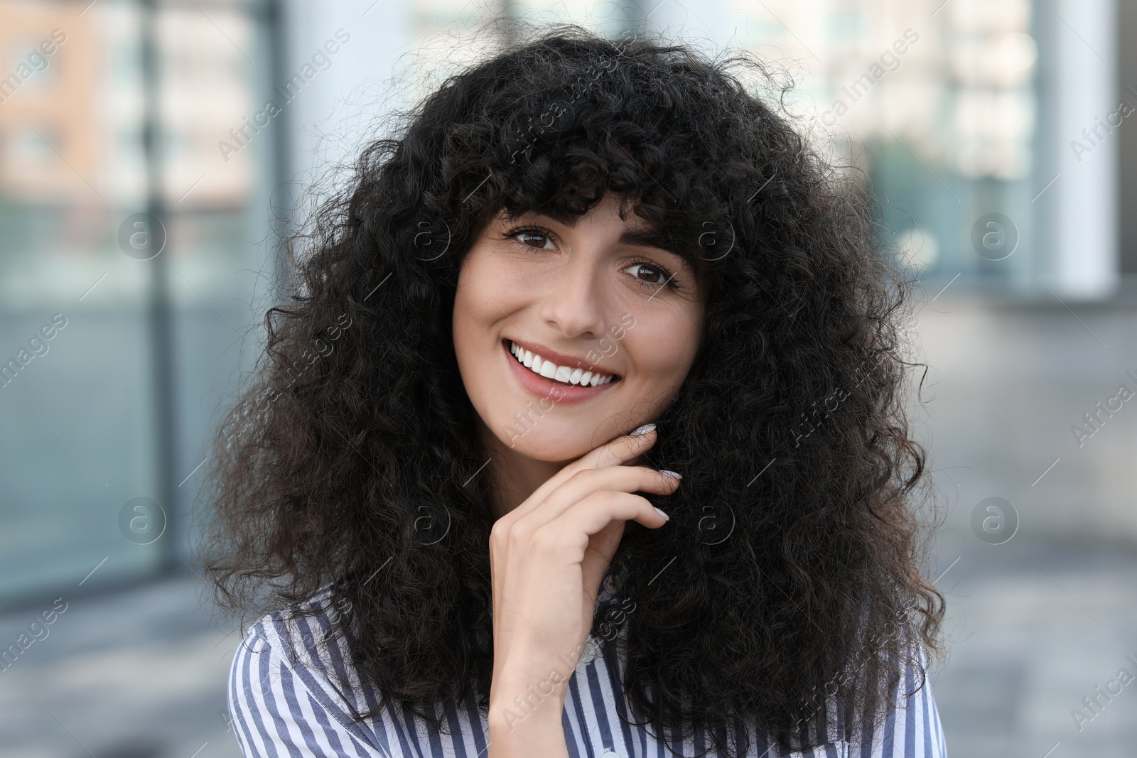 Photo of Portrait of beautiful woman outdoors. Attractive lady smiling and looking into camera