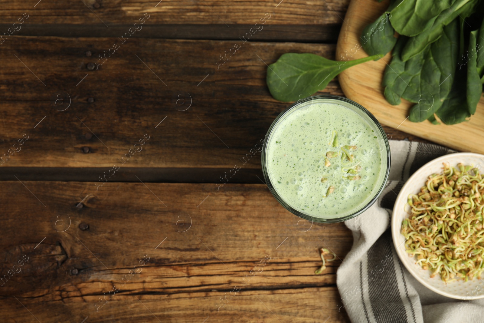 Photo of Flat lay composition with green buckwheat smoothie on wooden table, space for text