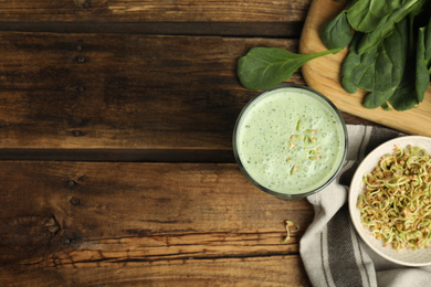 Photo of Flat lay composition with green buckwheat smoothie on wooden table, space for text