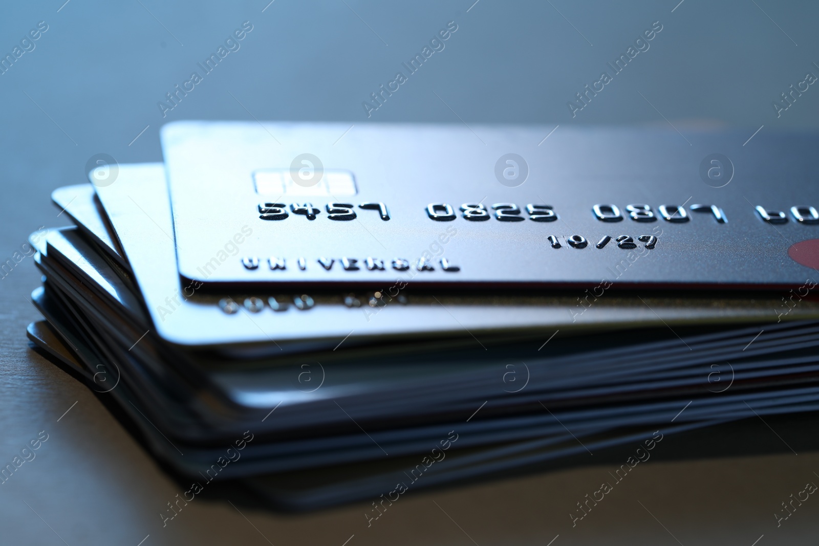 Photo of Many credit cards on gray background, closeup view