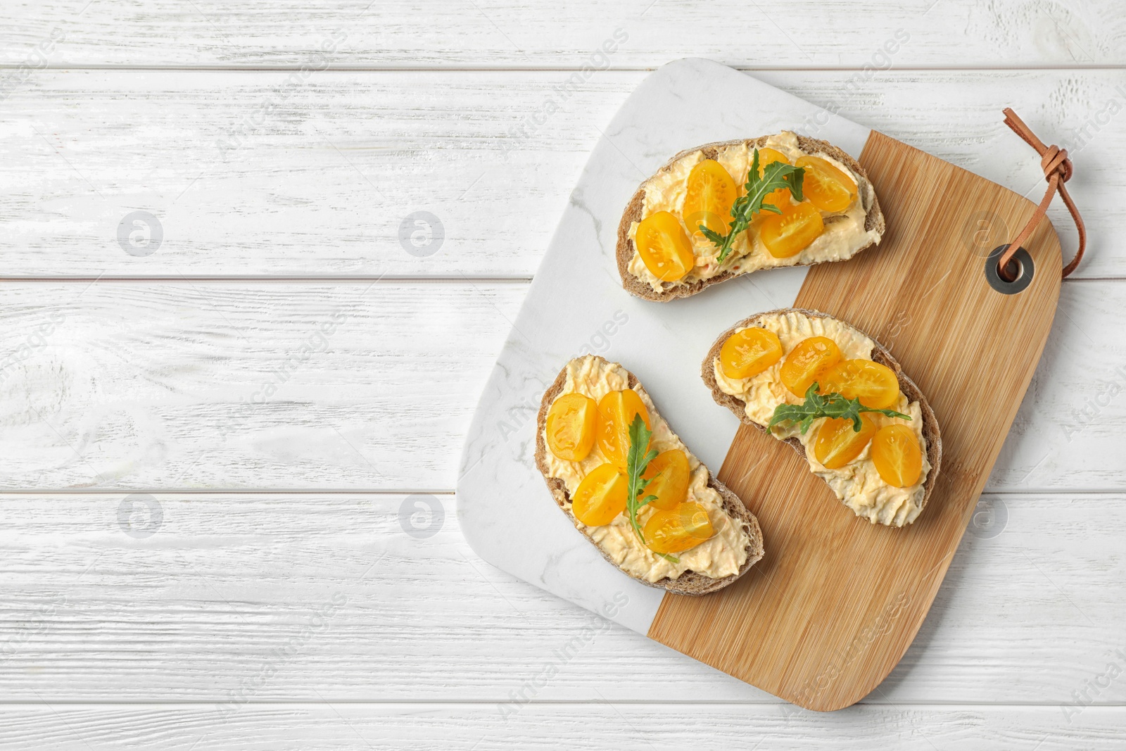 Photo of Tasty fresh tomato bruschettas on white wooden table, flat lay. Space for text