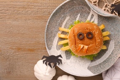 Photo of Flat lay composition with tasty monster sandwich for Halloween party on wooden table. Space for text