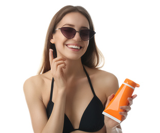 Photo of Young woman applying sun protection cream on white background