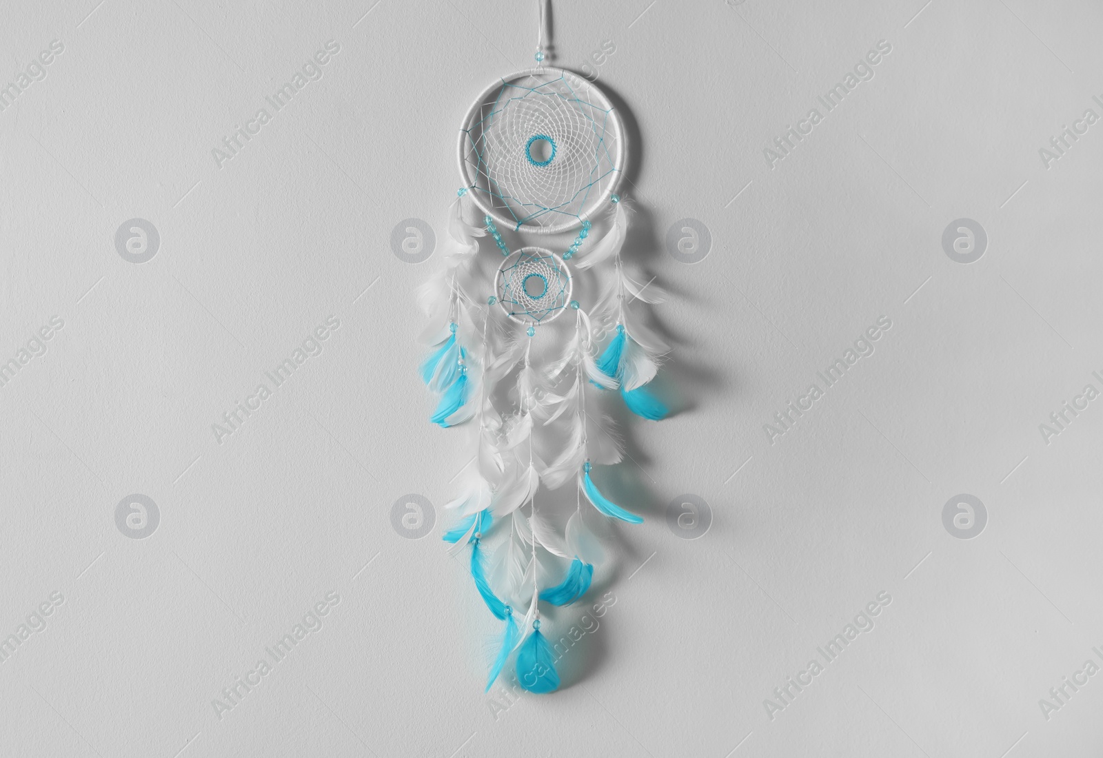 Photo of Beautiful dream catcher hanging on white wall