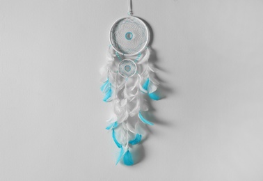 Photo of Beautiful dream catcher hanging on white wall