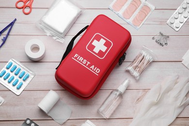 Flat lay composition with first aid kit on wooden table