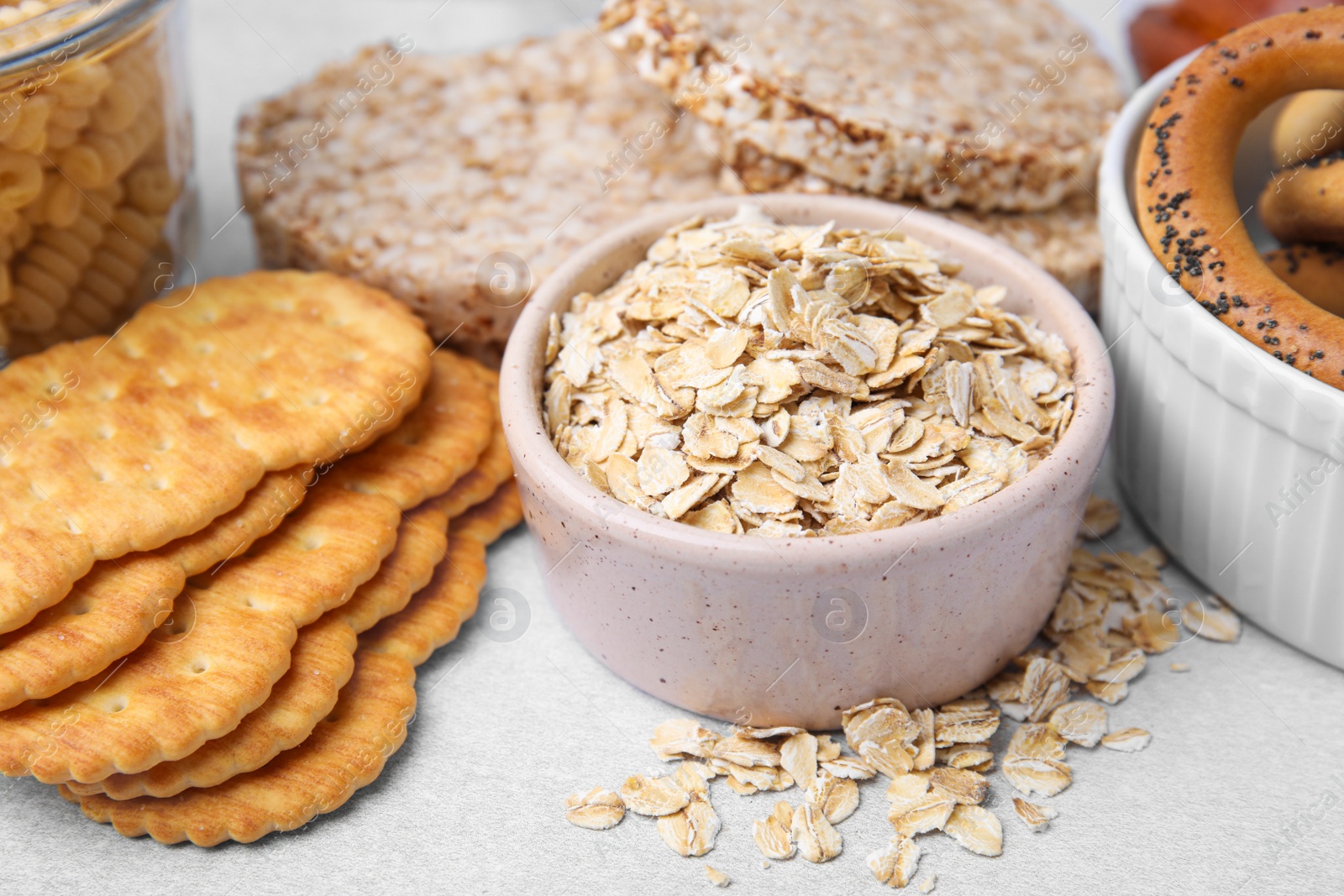 Photo of Different gluten free products on light grey table, closeup