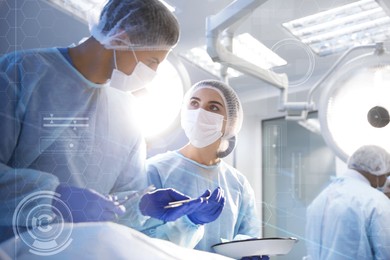 Image of Team of professional doctors performing operation in surgery room and illustration of different virtual icons
